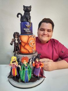 a man sitting in front of a halloween cake