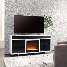 an entertainment center with a fireplace in the middle and a large screen tv above it