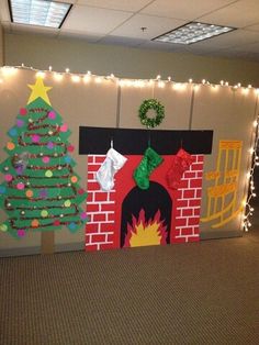 an office cubicle decorated for christmas with decorations and lights on the wall above it