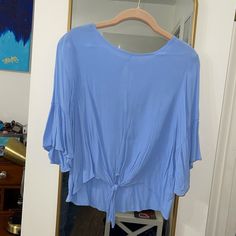 Beautiful Blue Cropped Tie Blouse With Ruffle Sleeves. Size Large. Never Worn And Perfect Condition. 50% Viscose 50% Tayon. Perfect For The Summer With Some Jean Shorts! I’m A Size 10 For Reference. Light Blue Flowy Blouse For Spring, Summer Blue Viscose Blouse, Blue Viscose Summer Blouse, Blue Viscose Blouse For Summer, Blue Rayon V-neck Top, Chic Blue Rayon Tops, Blue Rayon V-neck Blouse, Light Blue Short Sleeve Blouse For Brunch, Blue Flowy Short Sleeve Blouse