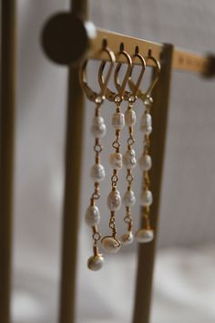 These Dangling Pearl String Earrings are handmade with genuine freshwater pearls, 22K gold-plated wire, and gold-filled leverback findings. A delicate yet sophisticated must-have for every jewellery collection. String Earrings, Bijoux Fil Aluminium, Earring Ideas, Pearl Earring, Ear Rings, Wrapped Jewelry, Jewellery Collection, 22k Gold, Wire Wrapped Jewelry