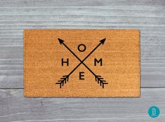 a door mat with arrows and the word home on it