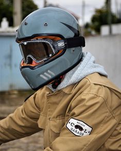 a person wearing a helmet and riding a motorcycle