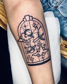 a tattoo on the arm of a person with a clock and stars in a cage