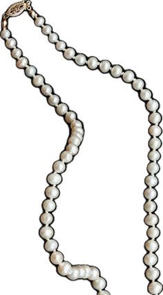 a white necklace with pearls on it