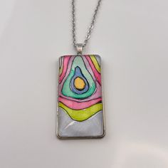 The lines in these paintings remind me of a topographical map. I imagine each of these pendants as a representation of a unique island that would be perfect for escaping the daily stressors of life. Six unique pendants were painted with these colors, and each is truly one of a kind! This pendant measures 1" wide by 2" tall (25mm x 50mm) and comes on an 22" chain. Jewelry comes on a presentation card in a white organza bag, ready to be gifted. Multicolor Hand Painted Spiritual Necklace, Colorful Artistic Jewelry For Gifts, Artistic Colorful Jewelry For Gifts, Spiritual Multicolor Hand Painted Necklace, Hand Painted Multicolor Spiritual Necklace, Multicolor Rectangular Pendant Necklace For Gift, Multicolor Artistic Pendant Necklace, Multicolor Necklace With Large Rectangular Pendant, Wearable Art Necklace With Large Pendant