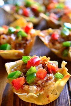 small cups filled with food sitting on top of a wooden table