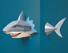 two paper sculptures of shark and shark's teeth