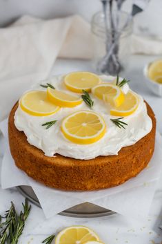 a cake with lemons and rosemary on top