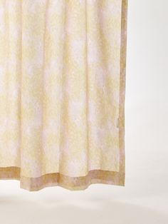 a yellow shower curtain hanging on a white wall