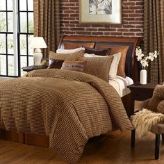 a bed in a room with brick walls