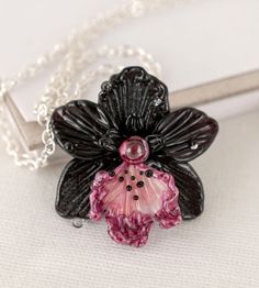 Flower necklace black orchid by ArtPalladisGlass. Costume jewelry Glass pressed flower jewelry for women birthday gift for her custom autumn jewelry pendant. Black orchid flower necklace pressed glass jewelry pendant is a great gift idea for birthsday. Custom necklace is handmade and unique. #necklaces #jewelrybeads #jewelrymaking Black Flower Jewelry For Gift, Unique Orchid-colored Jewelry As A Gift, Unique Orchid Jewelry For Gift, Unique Orchid Colored Jewelry For Gift, Unique Orchid-colored Jewelry Gift, Orchid Flower Pendant Jewelry For Gift, Orchid Flower Pendant Jewelry Gift, Black Glass Jewelry Gift, Black Flower Necklace For Gift