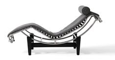 a black and white photo of a chaise lounge chair with grey fabric on it