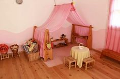 a room with pink walls and wooden floors