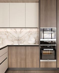 a modern kitchen with marble counter tops and white cupboards, along with wooden flooring