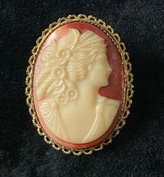 Vintage cameo brooch, retro goldtone basemetal pin, resin costume jewelry, cameo jewelry, mid century pin. Unmarked. A stunning vintage goldtone basemetal cameo brooch boasting the profile of a lady on a coral background. The brooch fastens with a secure pin and roll lock clasp and is in excellent pre-loved condition.  Measurements: Height: approx. 4 cm Length: approx. 2.5 cm Add sparkle to your life with my lovely vintage and brighten your life with a bit of whimsy!  Everything I sell is hand-selected for the highest quality, condition and design. All of my items are vintage and therefore usually have some wear consistent with their age. I describe my items as honestly and as accurately and to the best of my knowledge through both text and pictures, listing any known imperfections. UK del Coral Background, Cameo Jewelry, Vintage Cameo, Cameo Brooch, A Lady, Costume Jewelry, Brooches, Gold Tones, Im Not Perfect