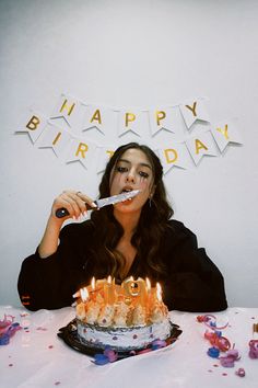 a woman is blowing out candles on her birthday cake