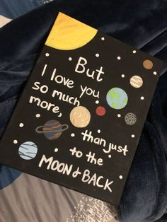 a book that is sitting on top of a bed with the words, i love you so much more than just to the moon and back