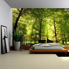 a bedroom with a large wall mural in the background and a bed on the floor