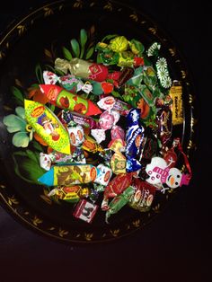 a bowl filled with assorted candy on top of a table