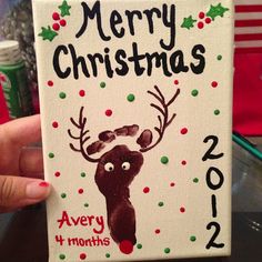 a hand holding up a christmas card with a reindeer on it and the words merry christmas 2012