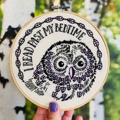 a person holding up a cross - stitch owl with the words trust my bedtime on it