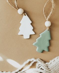 two wooden christmas trees hanging from twine