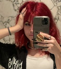 a woman with red hair taking a selfie