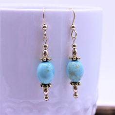 "A pair of turquoise earrings made with genuine Kingman Turquoise beads are complimented with antique gold filled beads and polished spacers, which create a visually pleasing stacked and balanced streamlined design. These simple minimalistic dangle earrings have antique and polished gold spacers, and hammered gold filled French ear wires with decorative beads for a polished finished look. These earrings match all my gold filled necklaces and bracelets so you can coordinate and wear multiple item Elegant Turquoise Beaded Earrings For Gift, Elegant Turquoise Beaded Earrings Nickel-free, Elegant Turquoise Beaded Earrings Nickel Free, Elegant Turquoise Earrings With Natural Stones, Turquoise Hypoallergenic Beaded Drop Earrings, Turquoise Dangle Earrings With Natural Stones, Hypoallergenic Turquoise Drop Earrings, Hypoallergenic Turquoise Oval Earrings, Turquoise Bead Earrings