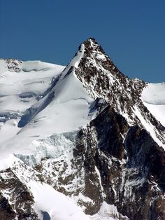 the top of a mountain covered in snow