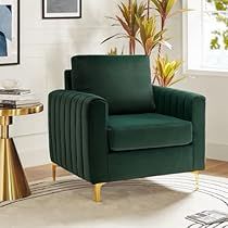 a green chair sitting in a living room next to a table and potted plant