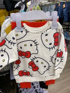 a hello kitty shirt hanging on a rack in a store