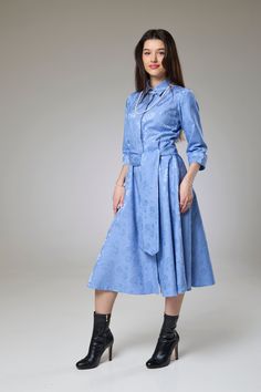 Step into the fresh allure of spring with our Sky Blue Petals Sleeved Dress. This elegant piece from our Dress – Sleeved collection combines the simplicity of a classic dress with the delicate charm of floral patterns and the added sophistication of long sleeves, creating a look that is both timeless and enchanting.  The long sleeves and classic shirt collar offer a versatile silhouette that transitions seamlessly from day to night, making it perfect for any occasion, from daytime outings to rel Feminine Semi-formal Spring Dresses, Feminine Blue Cotton Midi Dress, Spring Semi-formal A-line Dress, Fitted Midi-length Shirt Dress For Spring, Blue Cotton Midi Dress In Feminine Style, Fitted Midi Length Shirt Dress For Spring, Fitted Shirt Dress For Spring, Blue Cotton Midi Dress Feminine Style, Semi-formal Spring A-line Dress