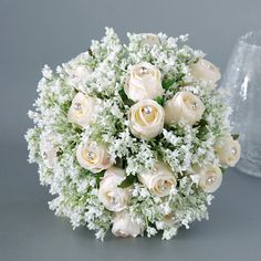 a bouquet of white roses and baby's breath