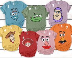 the faces of cartoon characters on different colored shirts are shown in front of a white wooden background