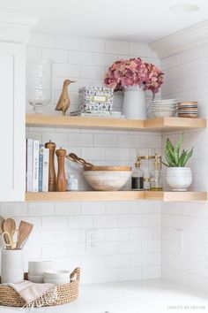 the shelves in this kitchen are filled with dishes and utensils, including bowls