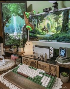 a computer keyboard sitting on top of a wooden desk in front of a tv screen