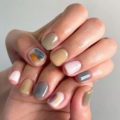 a woman's hand with some manies on it and two different colored nails