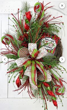 a christmas wreath with candy canes and greenery