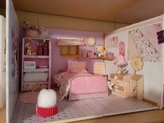 a doll's bedroom with pink furniture and accessories