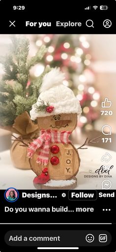 a wooden snowman ornament sitting next to a christmas tree