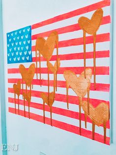 an american flag made out of paper and painted gold paint with hearts on the side