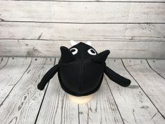 "Baby and Kids Black Bat Fleece Hat This is a bat hat made from black fleece. It features felt eyes, fleece teeth, fleece ears, and fleece wings. Hat Sizes: Baby: Approx. 20\" around Child: Approx. 22\" around Youth: Approx. 23 1/2\" around Hat shown is a child size on a 18 1/2\" (47cm) head. Care: Machine wash on cool or warm; dry on low. Turnaround time is 1-3 business days. Standard Shipping is usps first class (3-5 business days). Upgrade to priority (2-3 day) and priority express (1-2 day) Novelty Black Brimmed Mini Hats, Black Novelty Beanie Hat, Novelty Black Beanie Hat, Black Novelty Costume Cap, Black Beanie For Halloween, Novelty Black Mini Cap Hats, Bats For Kids, Squirrel Gift, Fleece Hats