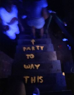 some people are walking up the stairs with signs on them that read party to way this