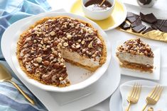 there is a pie with nuts on it next to other desserts and utensils