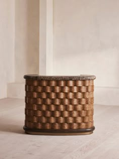 a brown basket sitting on top of a wooden table