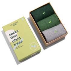 three pairs of socks that plant trees are in a box and one pair is green