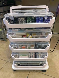 a stack of plastic containers sitting on top of a tiled floor