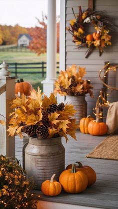 a porch decorated for fall with pumpkins and gourds