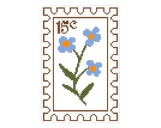 a cross stitch pattern with blue flowers on the front and back of a postage stamp